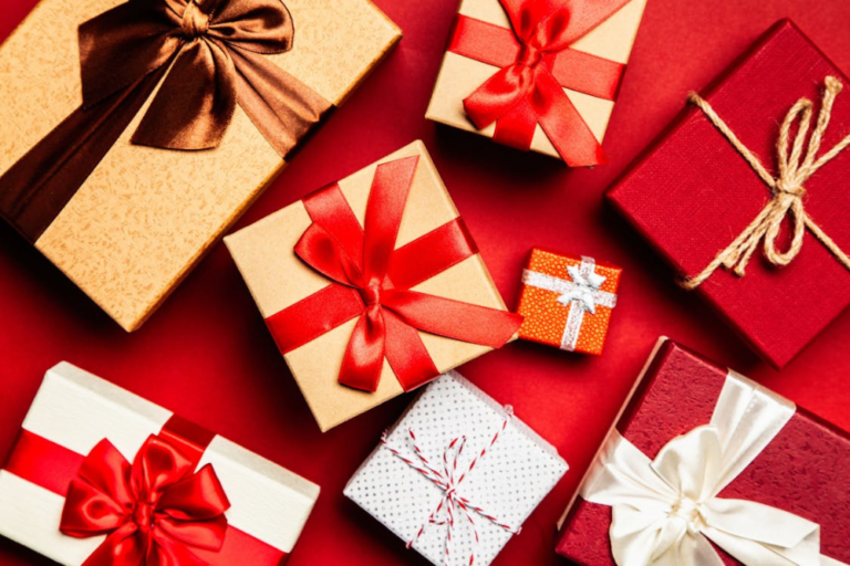 Festive gift boxes representing Olympia Aesthetics gift cards options for the holidays." Caption: "Give the perfect holiday gift with an Olympia Aesthetics gift card, redeemable for advanced skincare treatments.