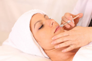 Woman receiving Restylane injection for forehead wrinkles at Olympia Aesthetics