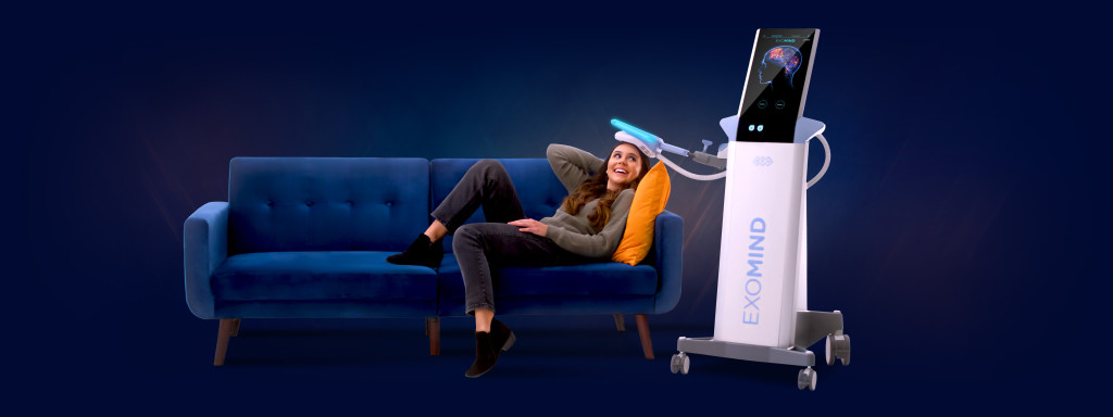 The BTL Exomind device with its ExoTMS applicator positioned over a relaxed patient during a brain wellness session in Palm Harbor