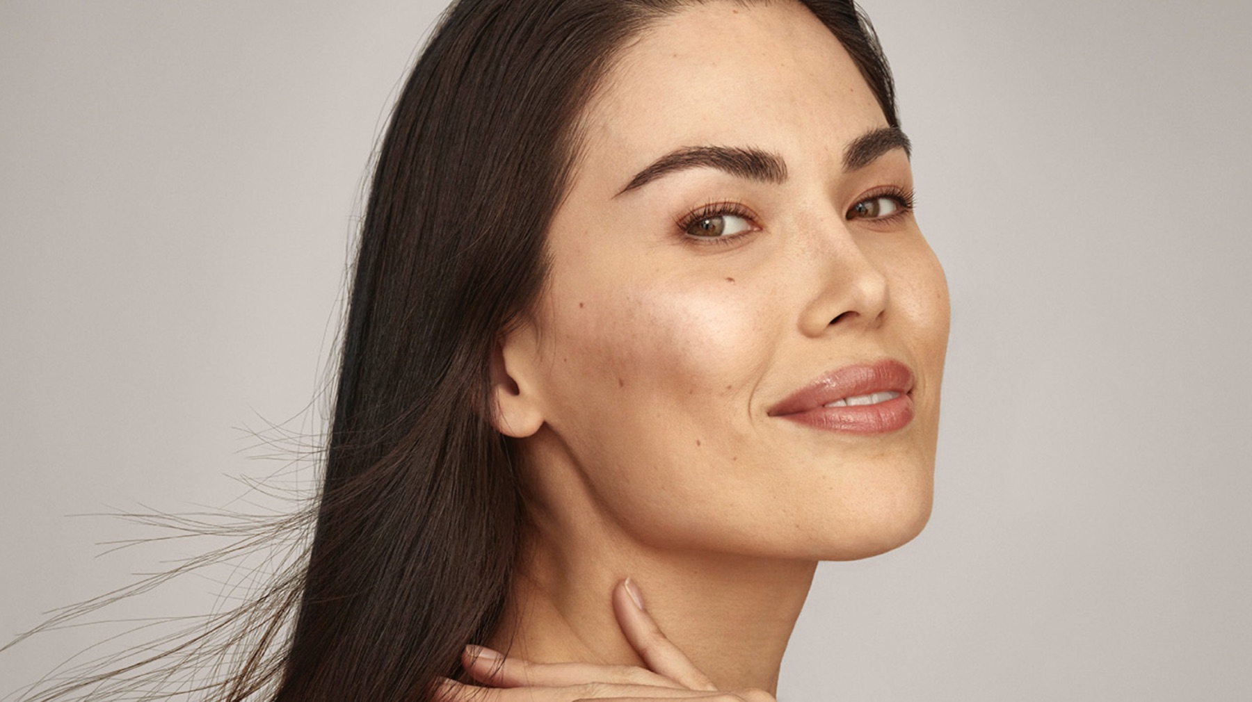 Woman with smooth, radiant, hydrated skin after SkinVive by Juvederm at Olympia Aesthetics in Palm Harbor, Florida