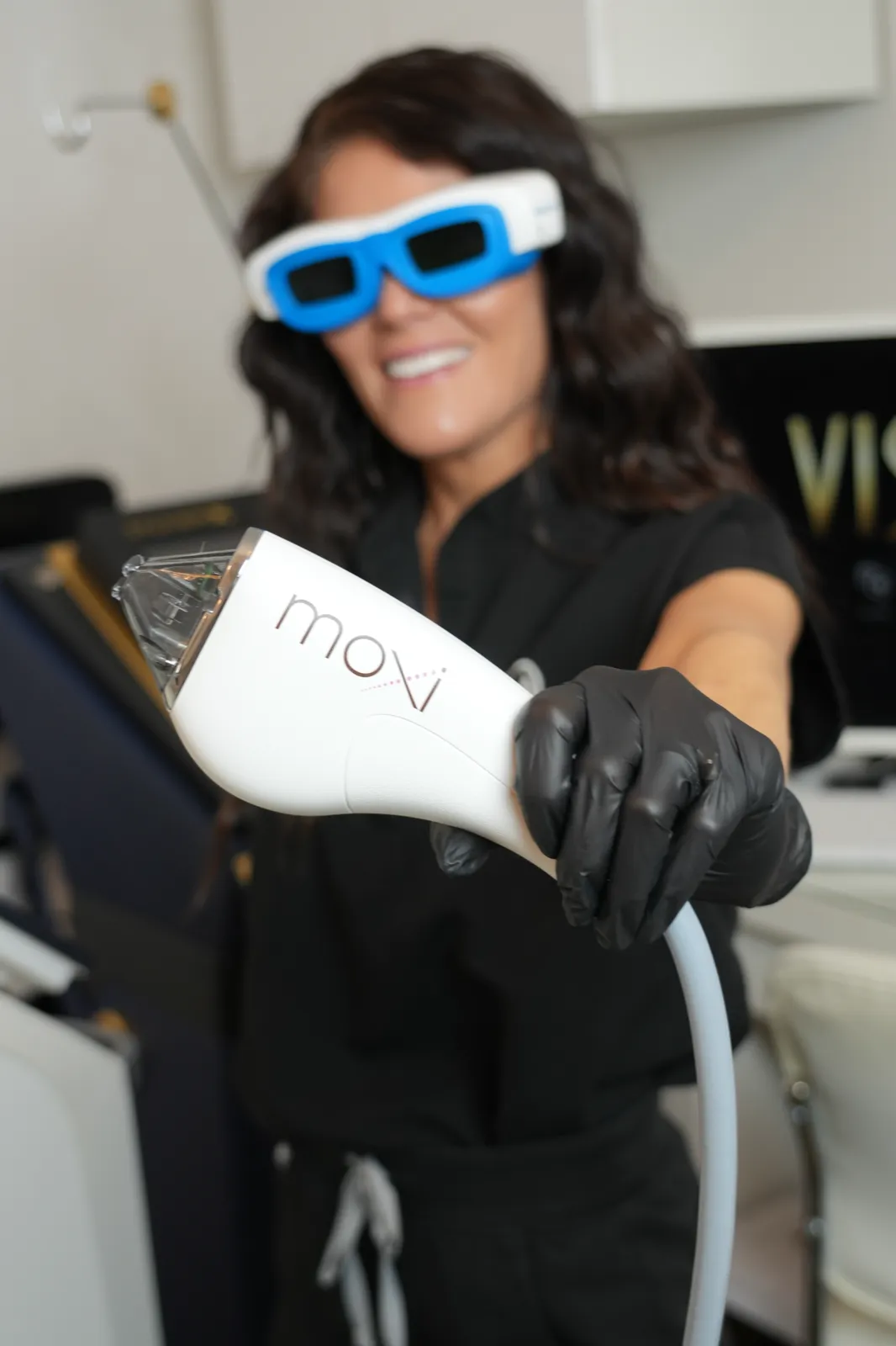 Olympia Morris, PA-C holding the Sciton MOXI laser handpiece at Olympia Aesthetics & Wellness in Palm Harbor, Florida