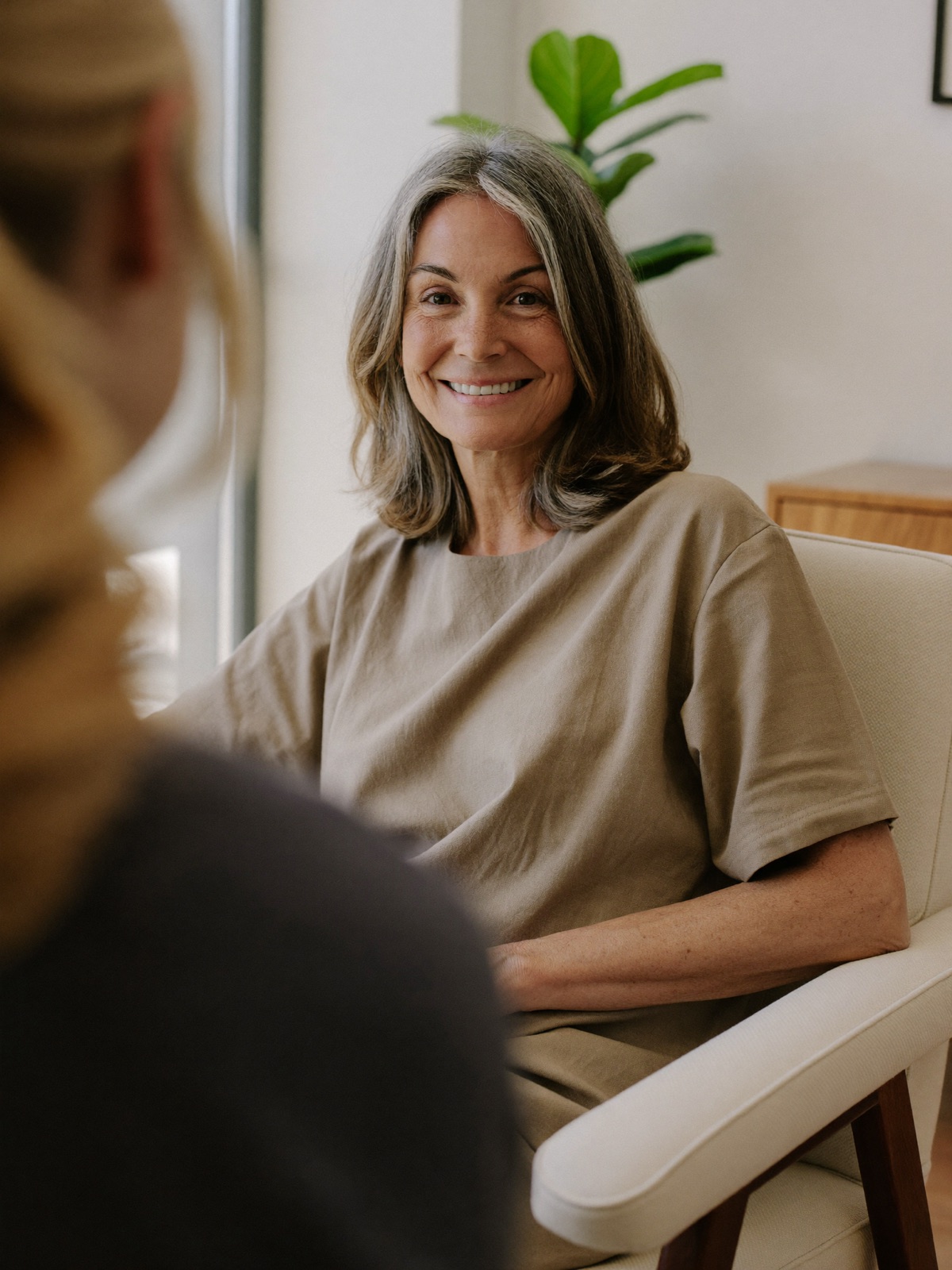 Woman in her early 50s during a BHRT consultation about perimenopause and menopause symptoms